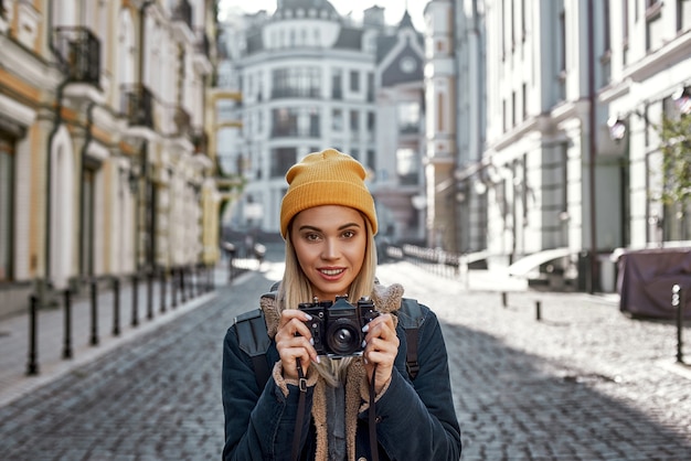 Young tourist blogger is walking with camera in old city