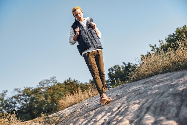 Young tourist blogger what walks at mountains bottom view