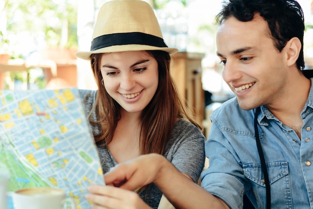 Young tourist couple are looking at a map