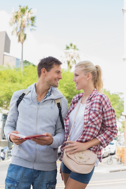 Young tourist couple consulting the guide book