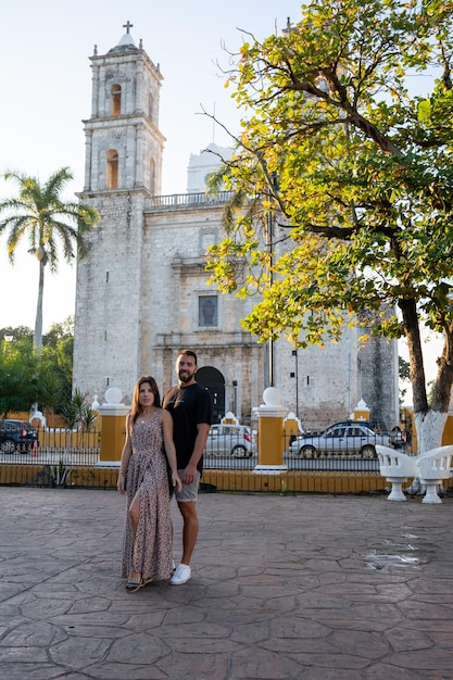 Young tourist couple in love in front of San Servacio Church in Valladolid Mexico