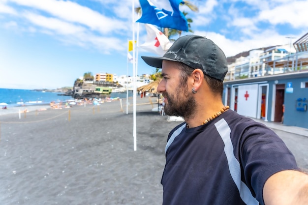 A young tourist enjoying the beach of Puerto Naos on the island of La Palma in summer