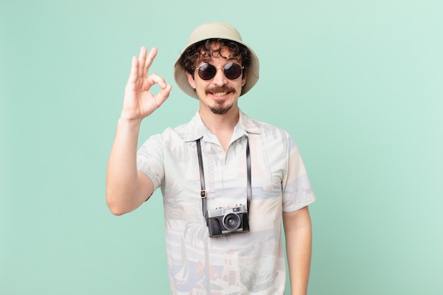 Young tourist feeling happy, showing approval with okay gesture