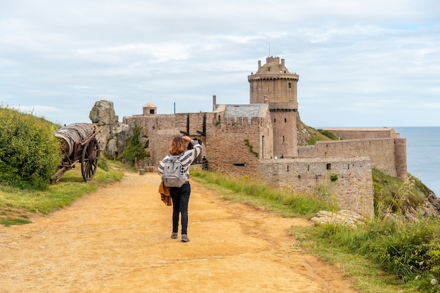 A young tourist at Fort-la-Latte castle next to Cape FrÃÂÃÂ©hel and near Saint-Malo, Plevenon peninsula, French Brittany. France