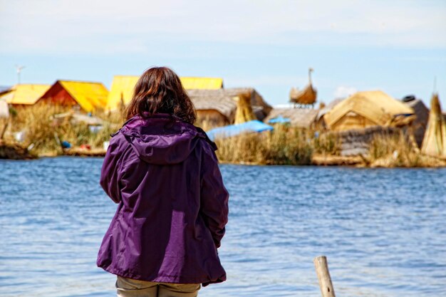 A young tourist in the house of the Uros Islands Peru