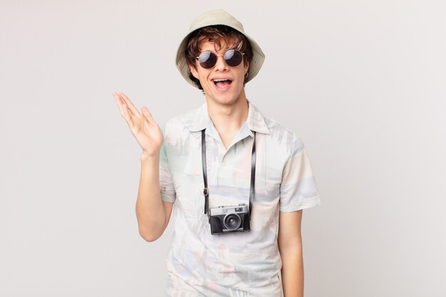 Young tourist man feeling happy, surprised realizing a solution or idea