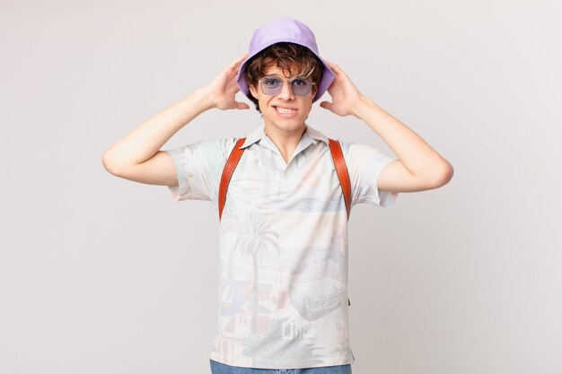 Young tourist man feeling stressed, anxious or scared, with hands on head