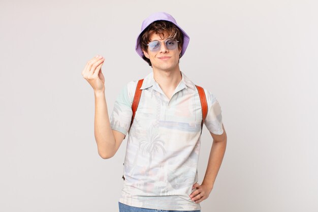 Young tourist man making capice or money gesture, telling you to pay
