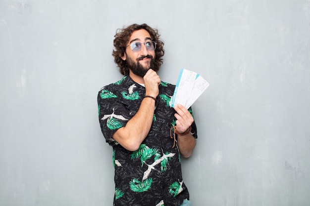 Young tourist man with boarding pass tickets