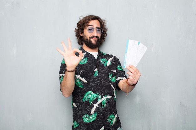 Young tourist man with boarding pass tickets