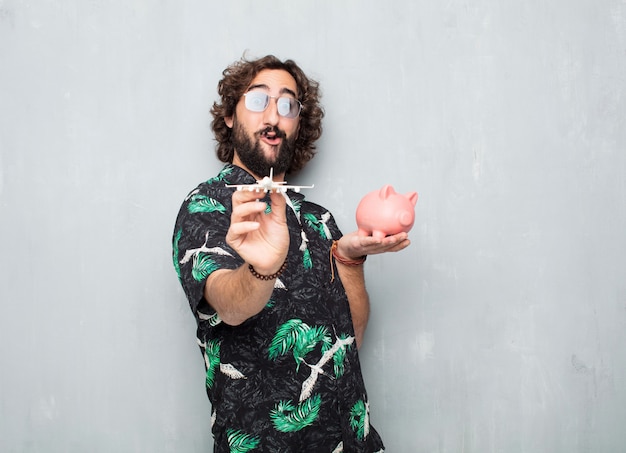 Young tourist man with a piggy bank