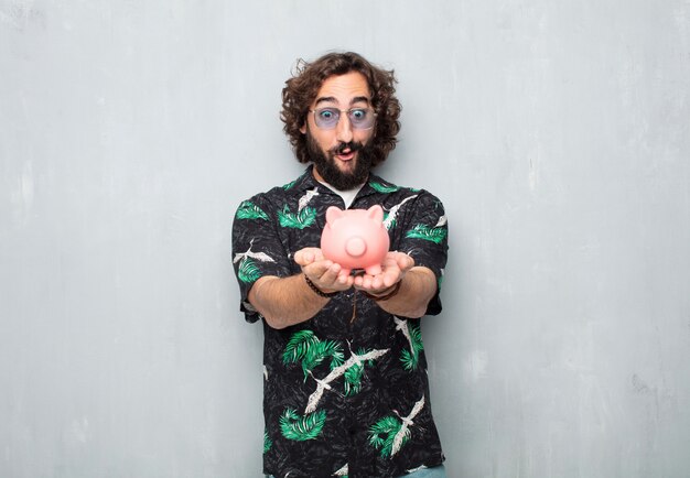 Young tourist man with a piggy bank