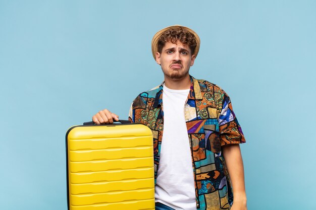 young tourist man with a suitcase