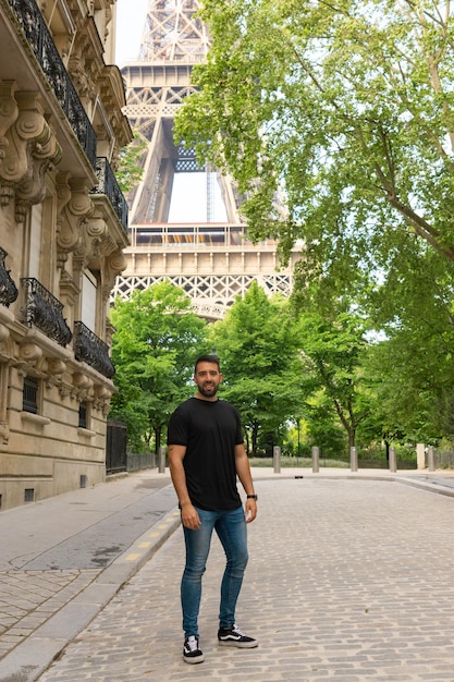 Young tourist on a Paris street with the Eiffel Tower in the background