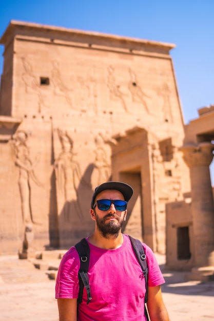 A young tourist visiting the Temple of Philae without people, a Greco-Roman construction, a temple dedicated to Isis, goddess of love. Aswan. Egyptian