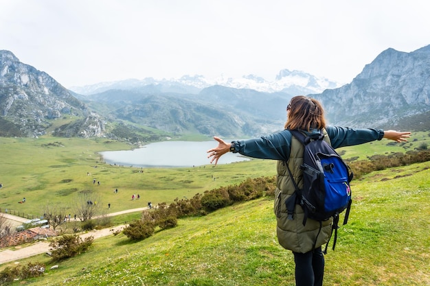 A young tourist with a backpack at the Entrelagos viewpoint of Lake Ercina in the Lakes of Covadonga Asturias Spain