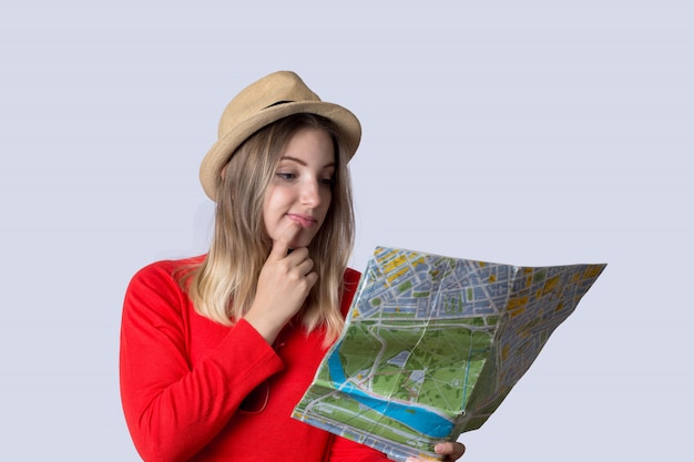 Young tourist woman looking at map.