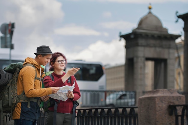 Young tourists check the route on the Navigator city map, Saint Petersburg