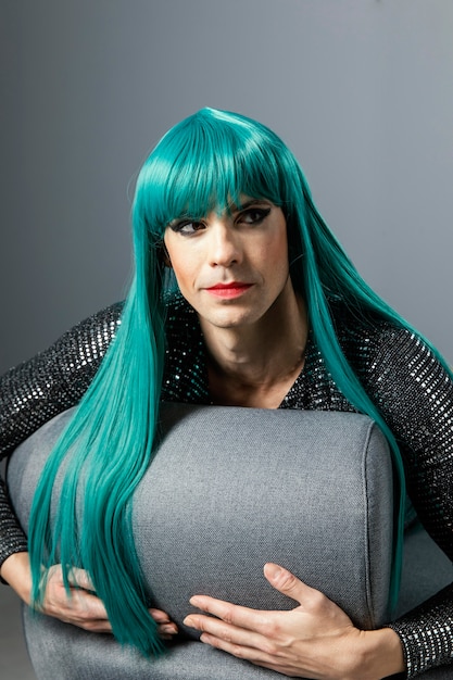 Young transgender person wearing green wig