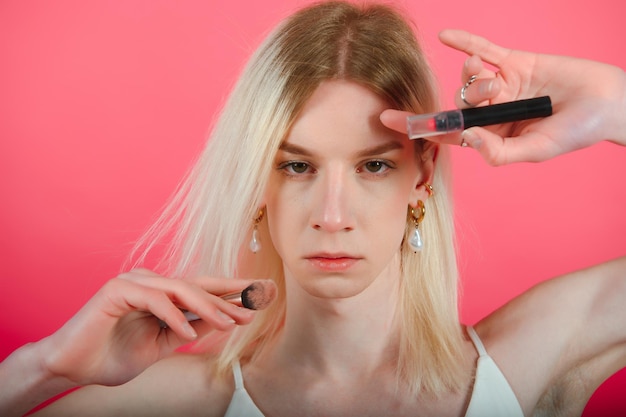 Photo young transgender woman on red background