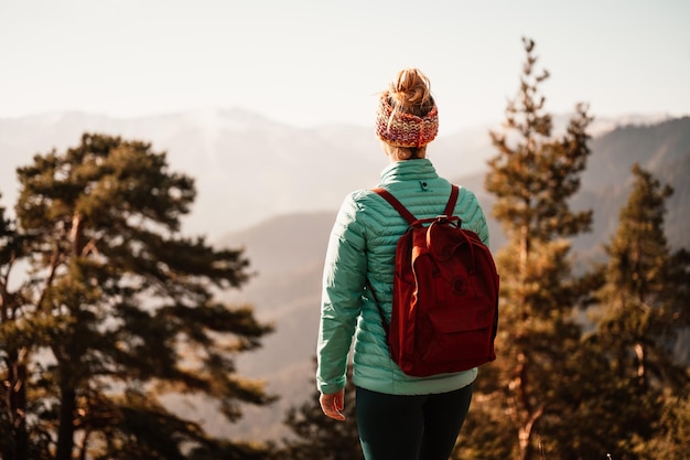 Young traveler hiking with backpacks hiking in mountains sunny\
landscape tourist traveler on background view mockup high tatras\
slovakia