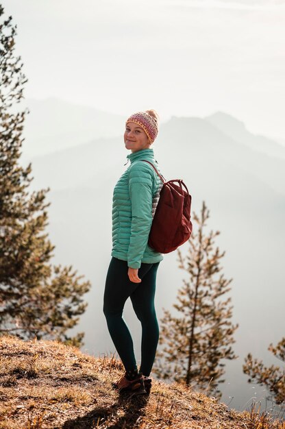 Young traveler hiking with backpacks hiking in mountains sunny\
landscape tourist traveler on background view mockup high tatras\
slovakia