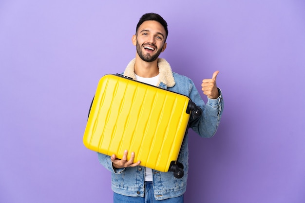 Young traveler holding a suitcase