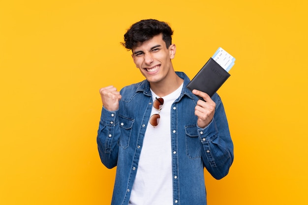 Young traveler man over isolated wall