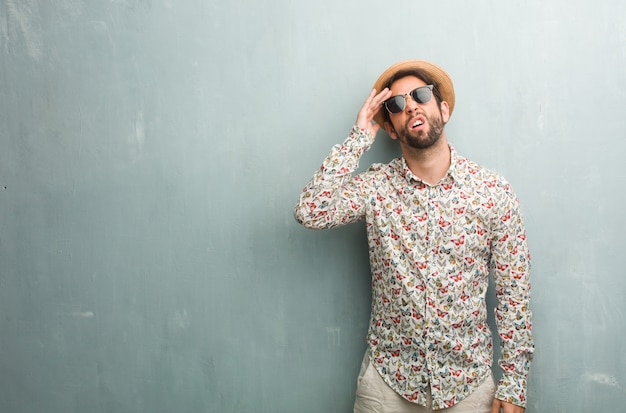 Young traveler man wearing a colorful shirt frustrated and desperate