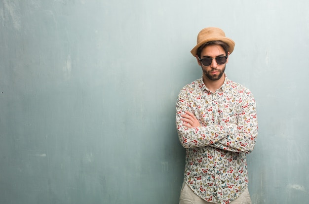 Young traveler man wearing a colorful shirt very angry and upset, very tense