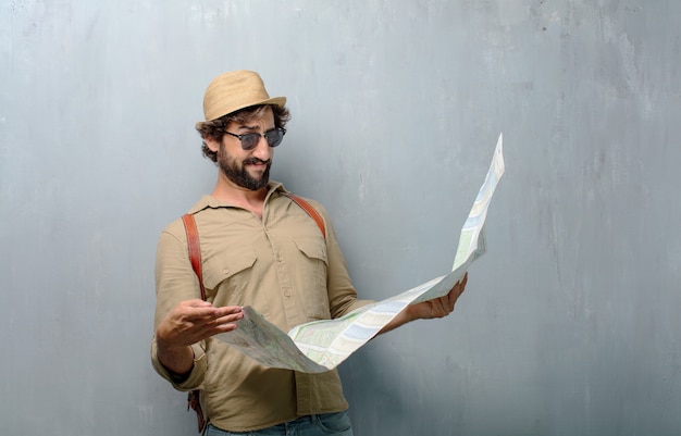 Young traveler man with a map and leather bag