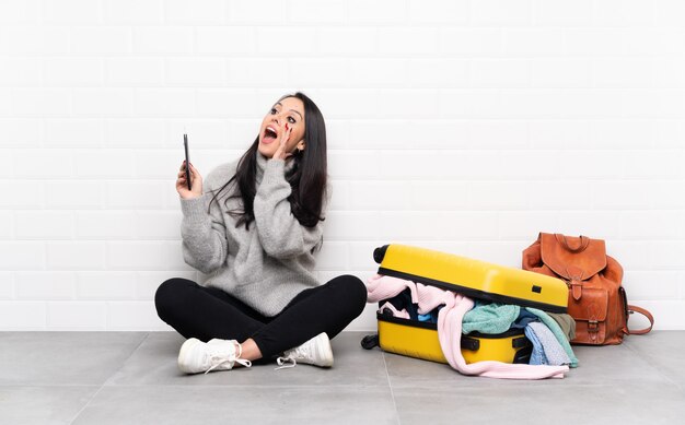 Young traveler woman over isolated wall