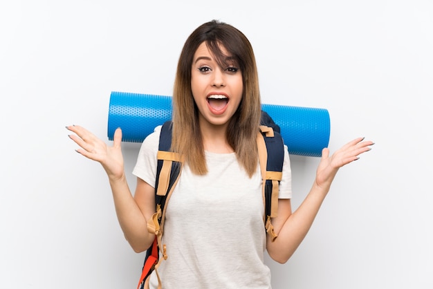 Young traveler woman over white background with shocked facial expression