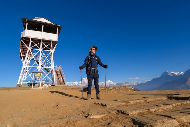 A young traveller trekking in Poon Hill view point in Ghorepani Nepal