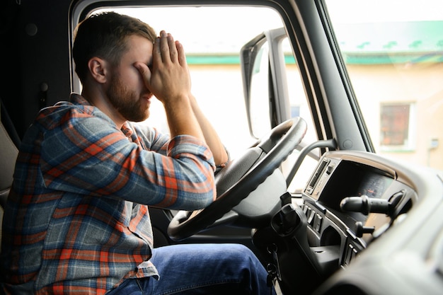 Young truck diver feeling tired and yawning during the ride