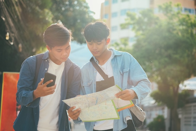 Young two men travel together in city on summer vacation.