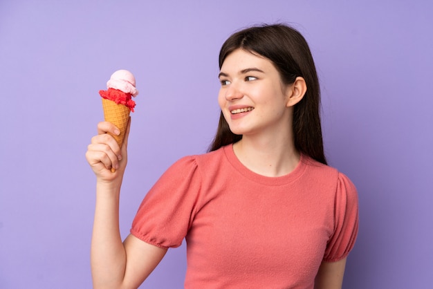 Young Ukrainian teenager woman holding a cornet ice cream with happy expression