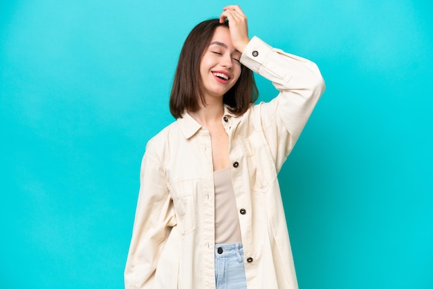 Young Ukrainian woman isolated on blue background has realized something and intending the solution