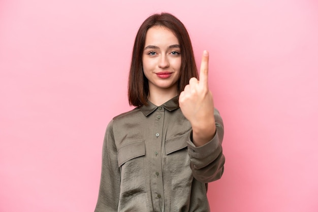 Young Ukrainian woman isolated on pink background doing coming gesture