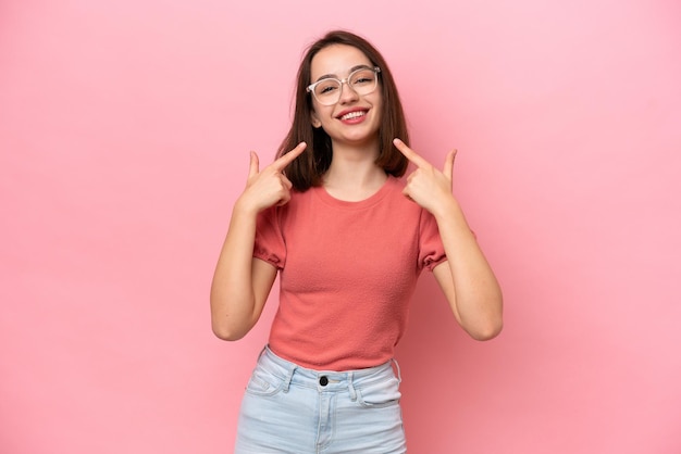 Young Ukrainian woman isolated on pink background giving a thumbs up gesture