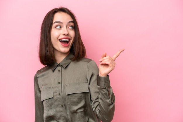 Young Ukrainian woman isolated on pink background intending to realizes the solution while lifting a finger up