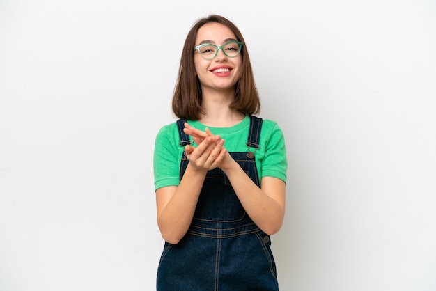 Young Ukrainian woman isolated on white background applauding after presentation in a conference