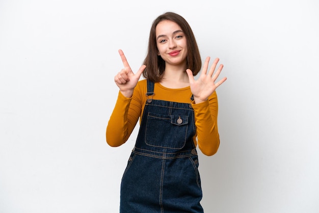 Young Ukrainian woman isolated on white background counting seven with fingers