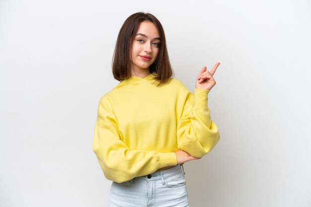 Young Ukrainian woman isolated on white background happy and pointing up