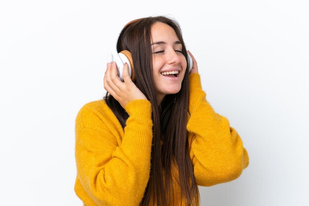 Young Ukrainian woman isolated on white background listening music and singing