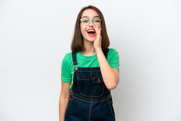 Young Ukrainian woman isolated on white background shouting with mouth wide open