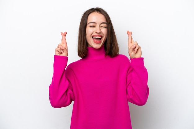 Young Ukrainian woman isolated on white background with fingers crossing