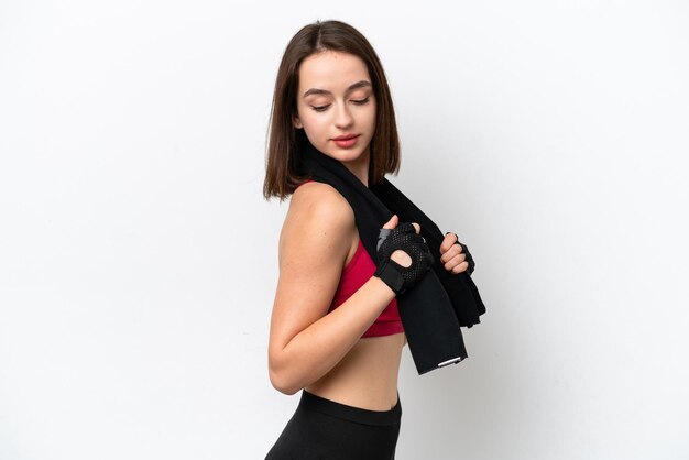 Young Ukrainian woman isolated on white background with sport towel