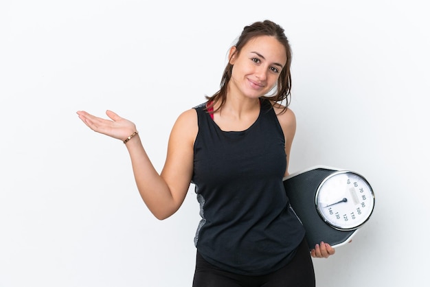 Young Ukrainian woman isolated on white background with weighing machine