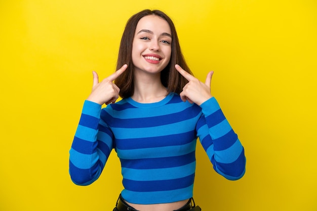 Young ukrainian woman isolated on yellow background giving a thumbs up gesture